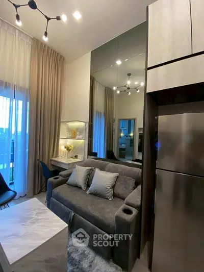 Modern living room with sleek design, plush sofa, and elegant lighting in a stylish apartment.