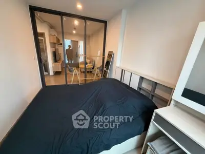 Modern bedroom with glass partition and stylish decor in a contemporary apartment.