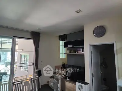 Cozy living area with modern decor and natural light, perfect for urban living.
