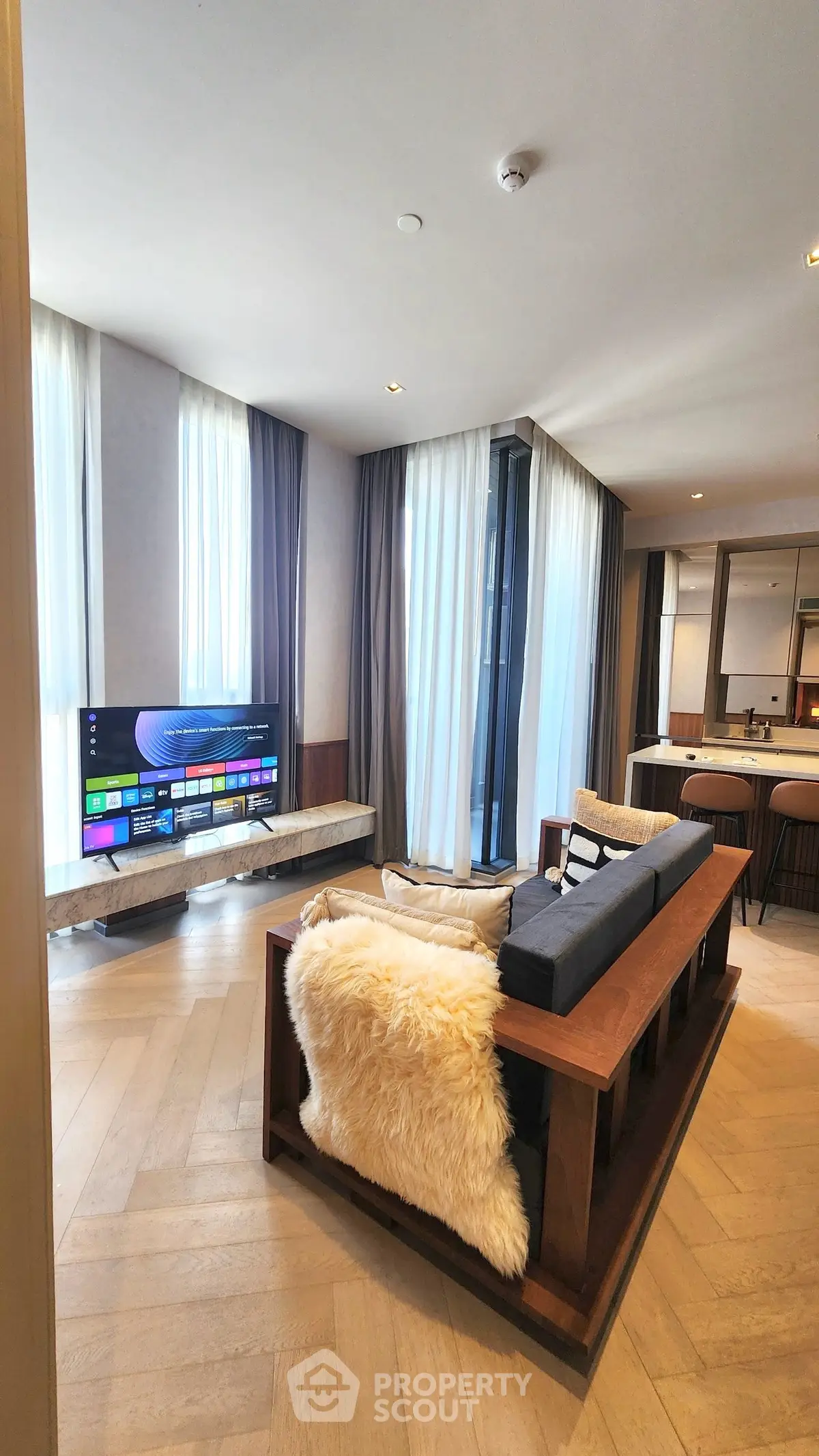 Luxurious modern living room with stylish decor and large windows