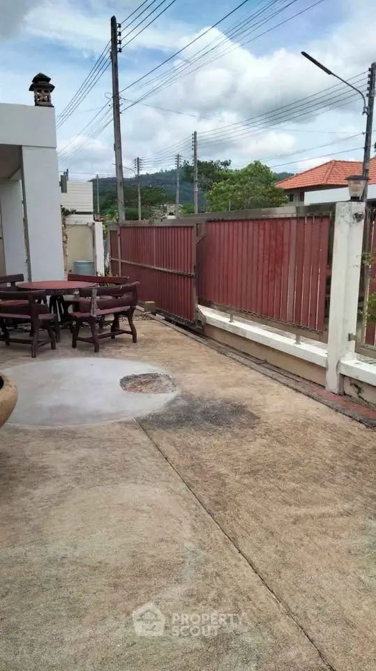 Spacious outdoor patio with seating area and scenic mountain view, perfect for relaxation and entertaining.