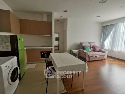 Spacious living room with modern kitchen and natural light