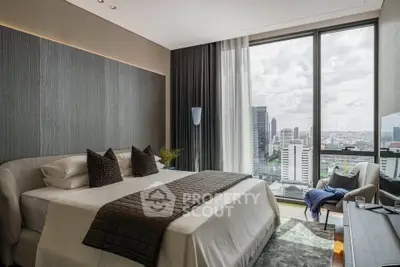 Luxurious bedroom with stunning city view, modern decor, and elegant furnishings in high-rise apartment.