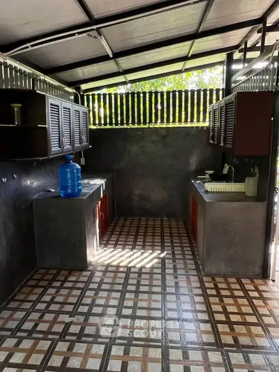 Charming outdoor kitchen with rustic design and natural light.