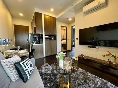 Modern living room with stylish decor and open kitchen layout in a contemporary apartment.