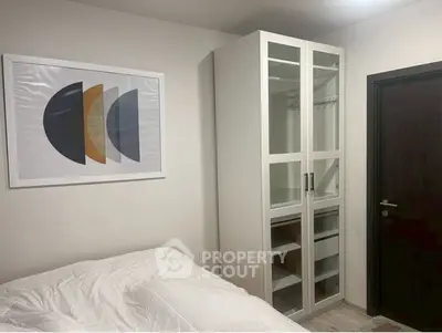 Cozy bedroom with modern wardrobe and stylish wall art