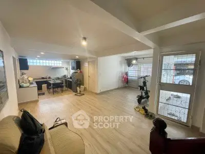 Spacious open-plan living room with modern kitchen and natural light.