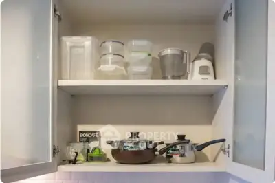 Modern kitchen cabinet with cookware and storage containers