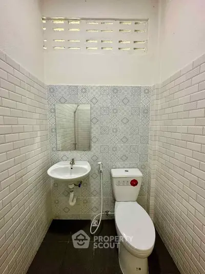 Compact bathroom with modern fixtures and stylish tile design, perfect for efficient space utilization.