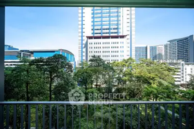 Stunning urban view from a balcony overlooking lush greenery and modern high-rise buildings.