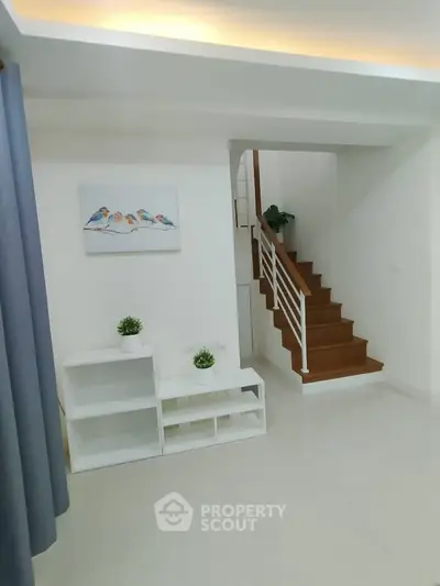 Modern interior with staircase and minimalist decor in a bright living space.