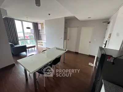 Spacious modern living room with dining area and large windows