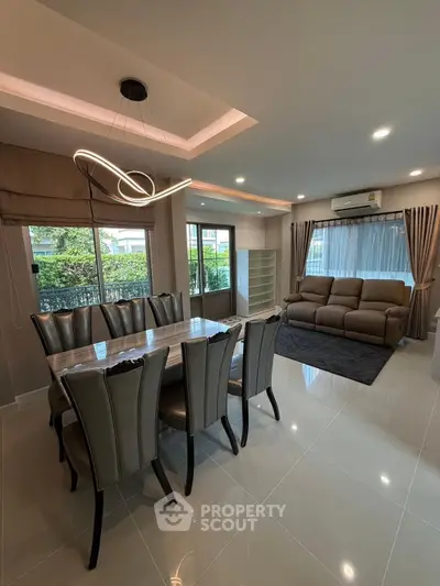 Modern living room with elegant dining area and stylish lighting