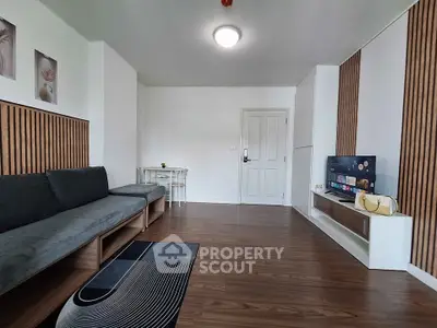 Modern living room with sleek wooden flooring and stylish decor