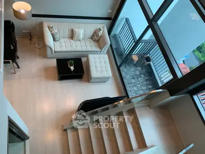 Modern living room with large windows and balcony view