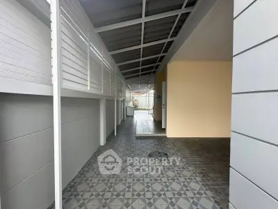 Modern covered walkway with stylish tile flooring and sleek design