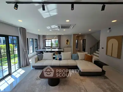 Spacious modern living room with large windows and stylish furniture in a luxury home