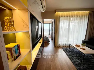 Modern living room with elegant decor and city view, featuring a cozy seating area and stylish shelving.