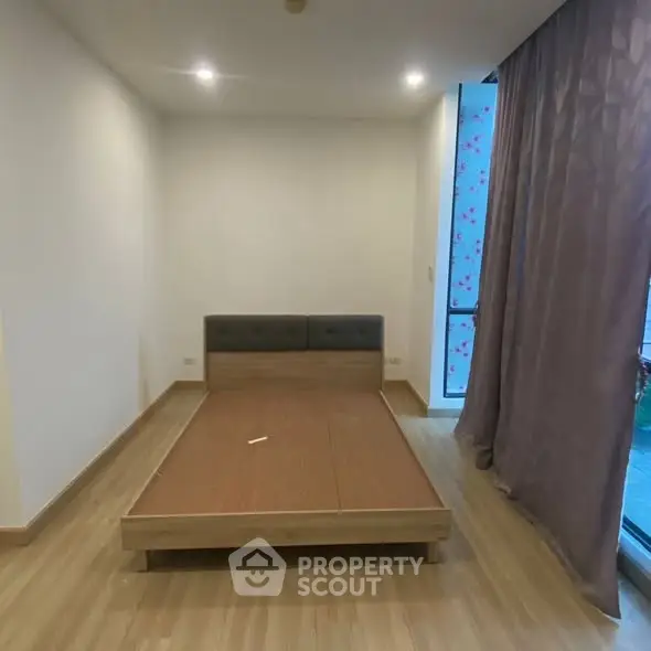 Spacious bedroom with modern design and large window for natural light