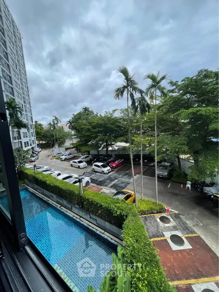 Scenic view of residential building with pool and parking area