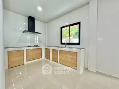 Modern kitchen with sleek design and gas stove in a bright, spacious layout.