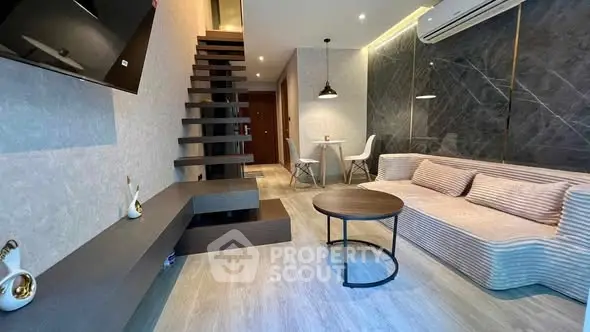 Modern living room with stylish staircase and cozy seating area