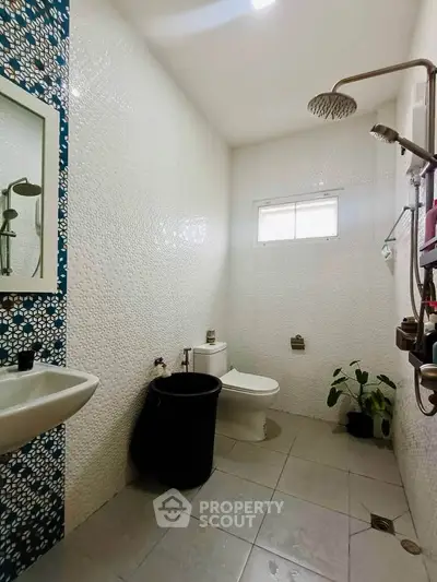 Modern bathroom with stylish shower and decorative wall tiles