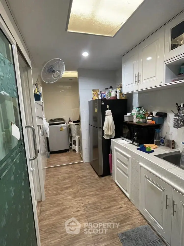 Compact kitchen with modern appliances and sleek cabinetry