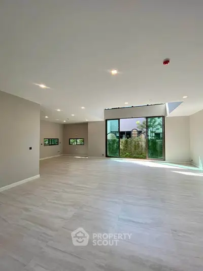 Spacious modern living room with large windows and garden view