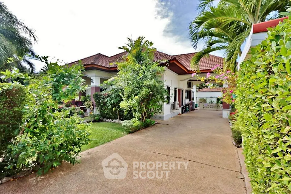 Charming tropical villa with lush garden and spacious driveway, perfect for serene living.