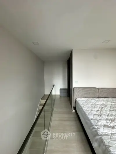 Modern bedroom with minimalist design and glass railing