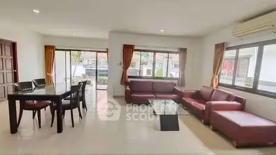 Spacious living room with modern furniture and large windows for natural light.