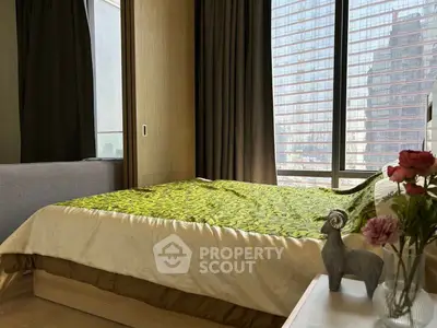Luxurious bedroom with floor-to-ceiling windows and elegant decor in a modern high-rise apartment.