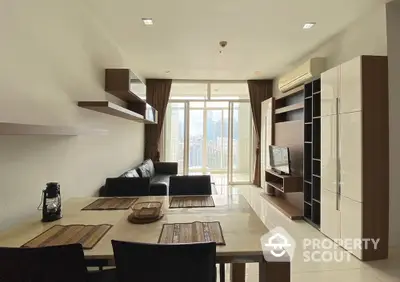 Modern living room with city view, sleek furniture, and open layout in high-rise apartment.