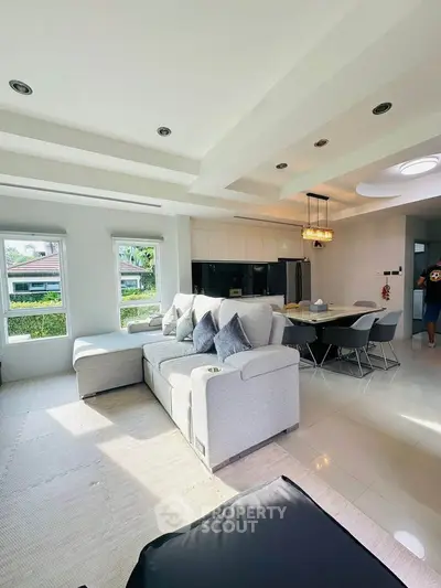 Spacious modern living room with elegant dining area and natural light
