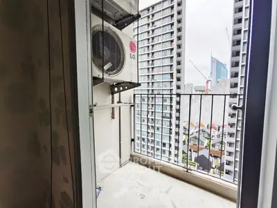 Urban balcony with city view and air conditioning unit, perfect for modern living.