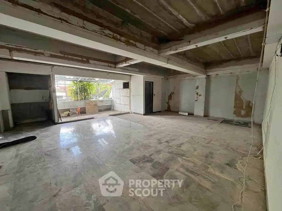 Spacious unfinished room with large windows and potential for customization.