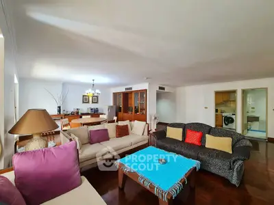 Spacious living room with cozy seating and open kitchen layout