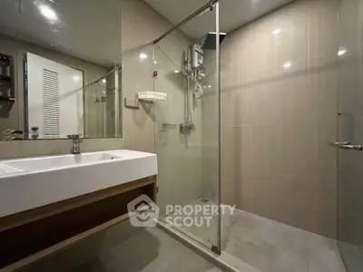 Modern bathroom with glass shower enclosure and sleek sink design