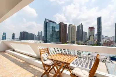 Stunning city view from spacious balcony with modern skyline backdrop.