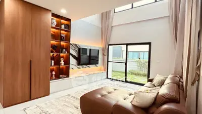 Spacious modern living room with high ceiling and large windows