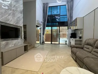 Spacious modern living room with high ceilings and large windows