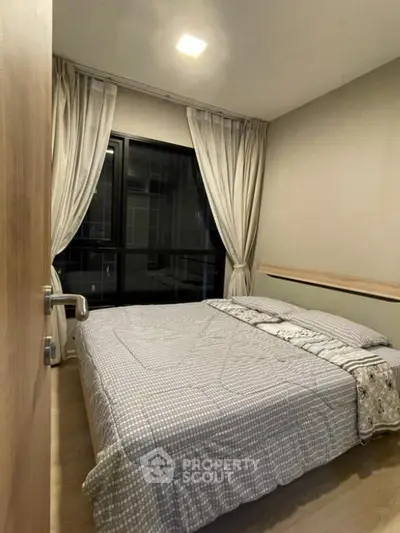 Cozy bedroom with modern decor and large window view