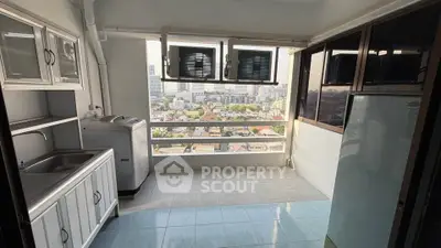 Spacious balcony with city view and modern appliances in urban apartment