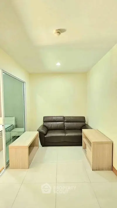 Cozy living room with modern sofa and minimalist design, perfect for relaxation and comfort.