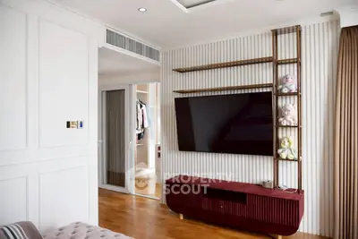 Modern living room with wall-mounted TV and stylish shelving