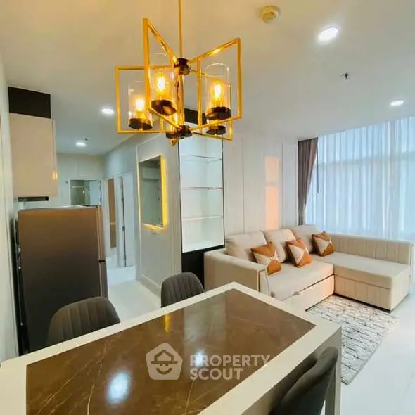 Modern open-layout living room with stylish dining area and cozy seating.