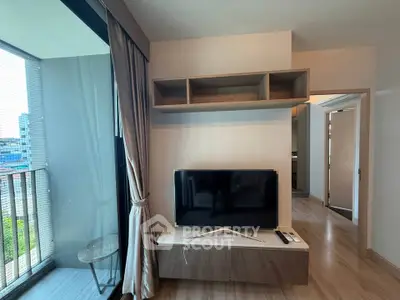 Modern living room with TV and balcony view in stylish apartment