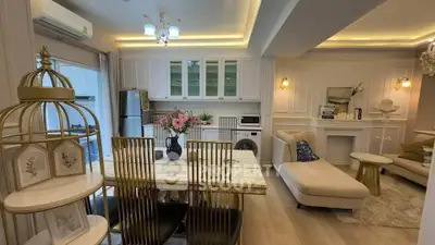 Luxurious open-plan living room with elegant dining area and modern kitchen appliances.