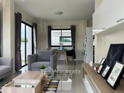 Modern living room with stylish furniture and large windows